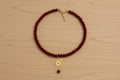 Collier rouge et soleil