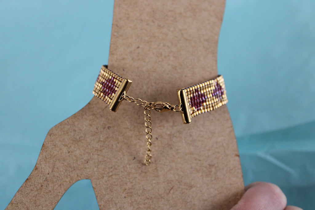 Bracelet doré losanges rouges